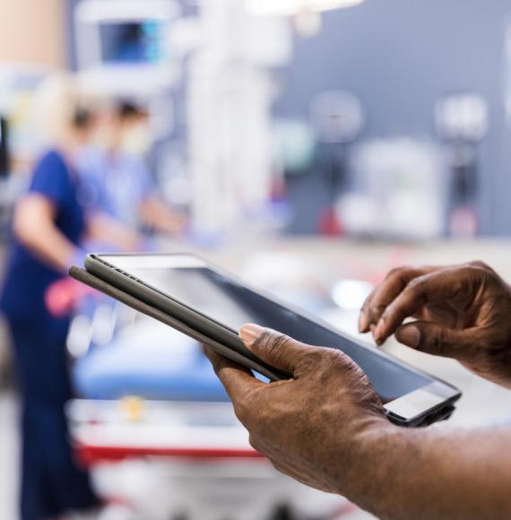 Health professional holding a tablet depicting digital transformation