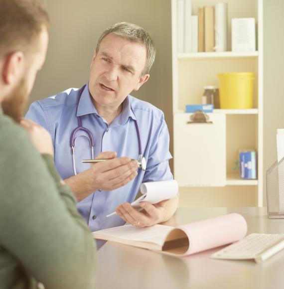 Doctor consulting man about patient safety