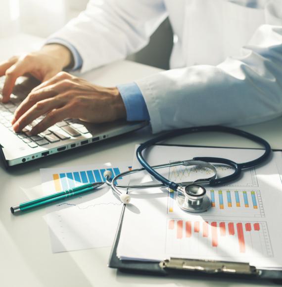 Doctor working with paperwork depicting the new equality, diversity and inclusion figures from the new workplace disability standard data