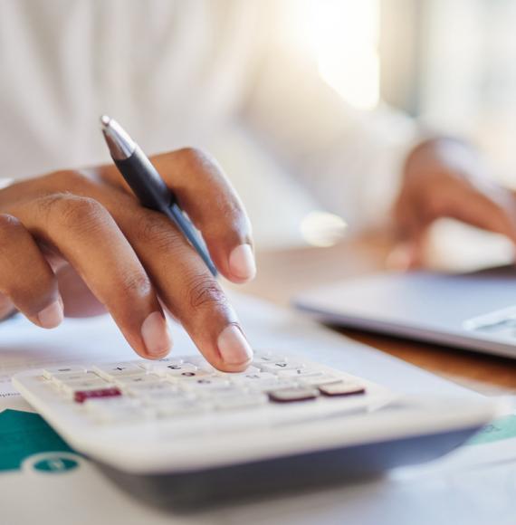 Person using a calculator depicting the Health Foundation's analysis that shows most people want extra funding for the NHS