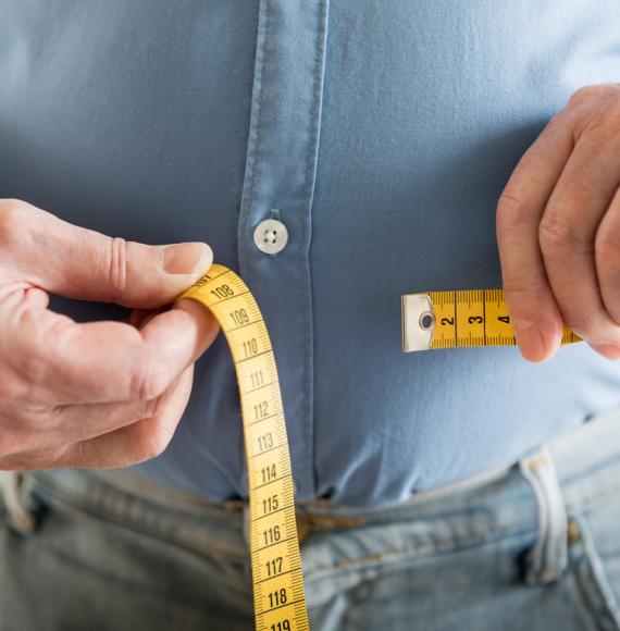 Person measuring their waist depicting type 2 diabetes treatment