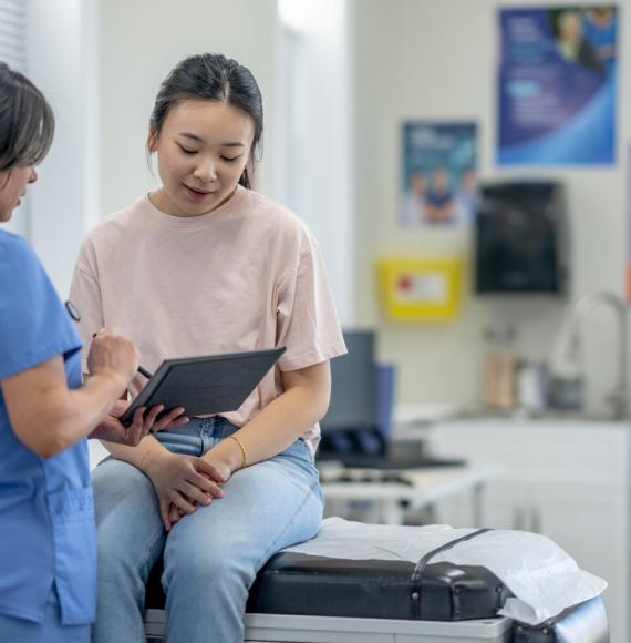 Nurse consulting a patient depicting a women's health appointment