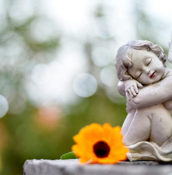 Angel guardian sleeping on a grave depicting Scot Govt's new baby loss memorial book