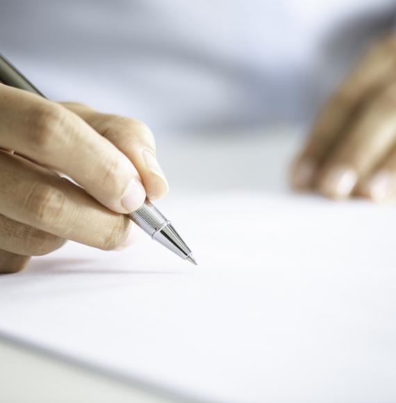 Image a person signing a contract depicting the NHS sexual safety charter