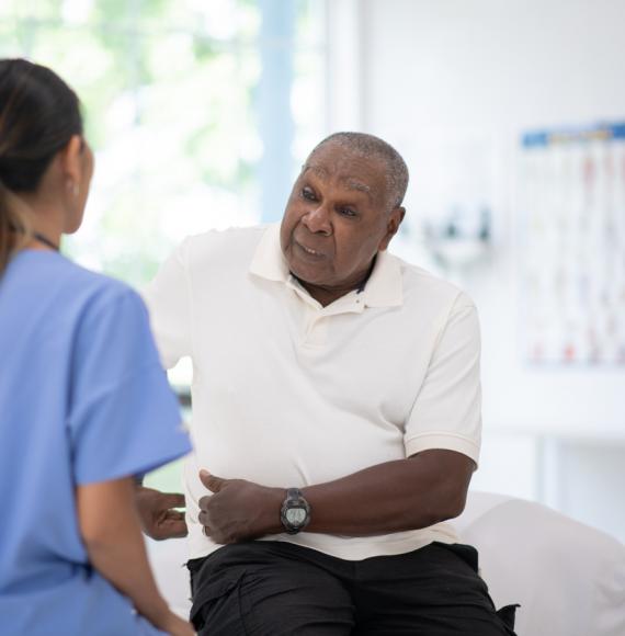 An Elderly Gentleman in His Doctors Office Receiving a Check-Up