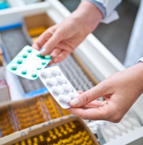 Female pharmacist holding medicines