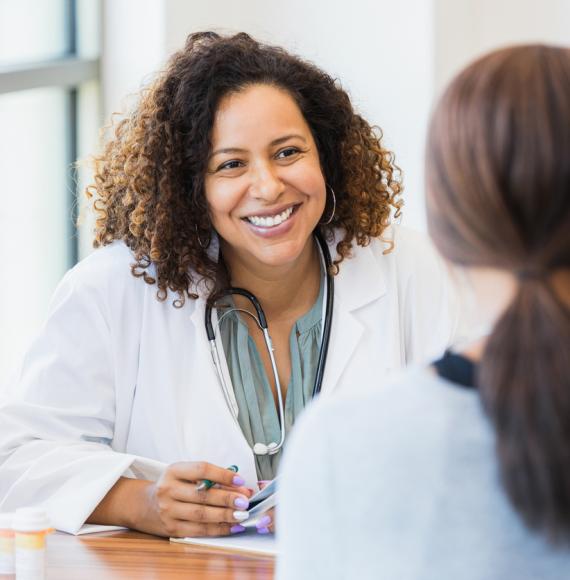 Image of a female doctor with a patient depicting NHS Scotland's new menopause and menstrual health policy