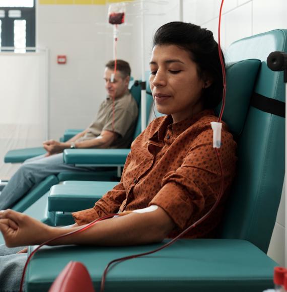 Young woman and mature man giving blood for sick patients