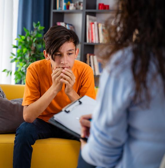 Psychologist with young boy in an office