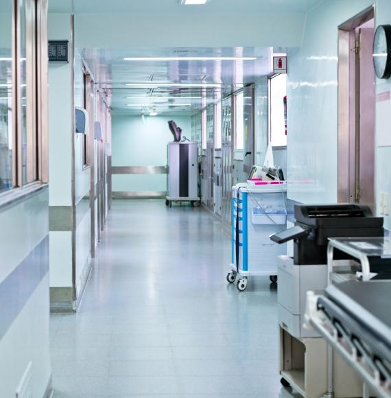 Illuminated corridor at modern hospital