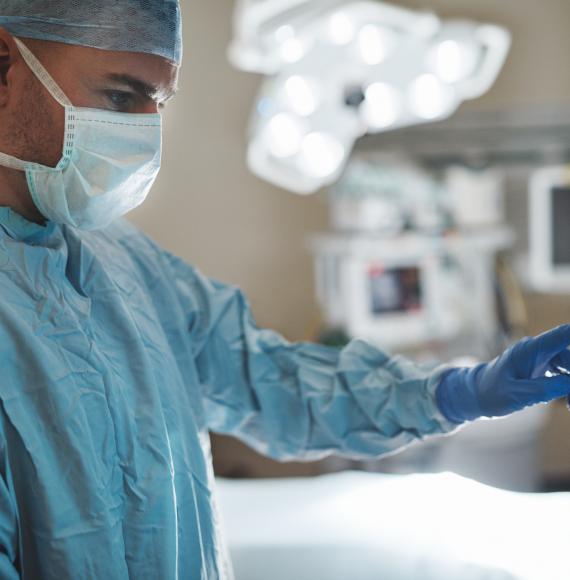 surgeon looking at a monitor in an operating room