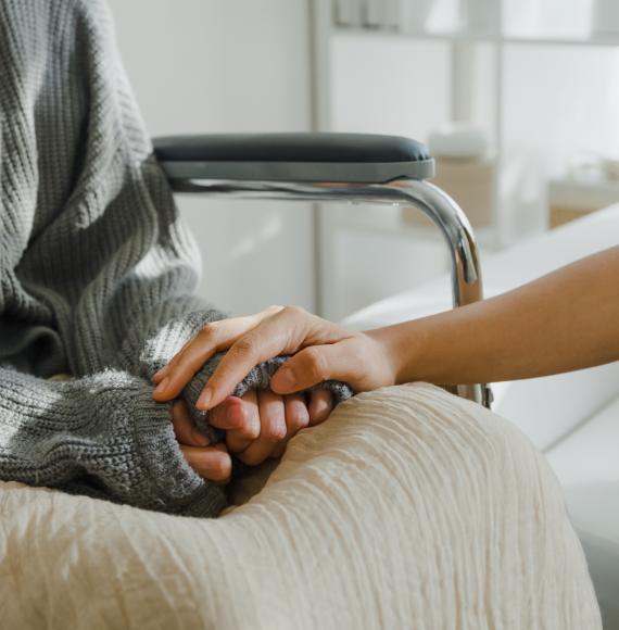 Close up of two people holding hands, one has leukemia
