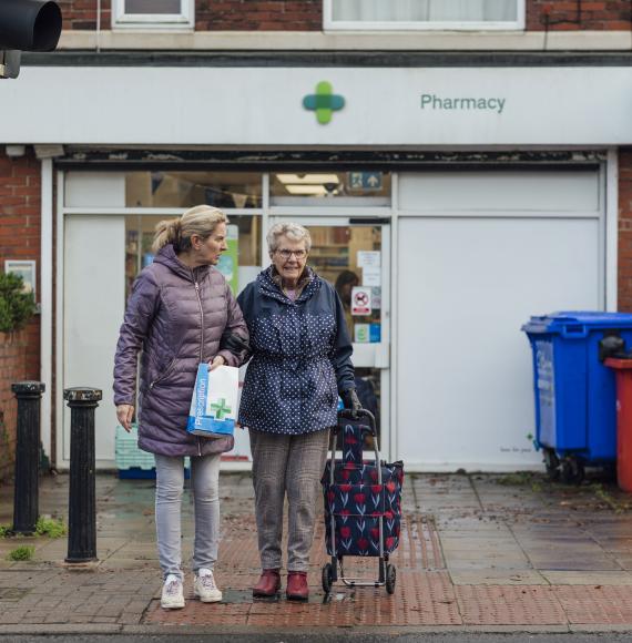 Two people leaving a pharmacy