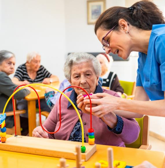 Occupational therapist supporting a patient with a neurological condition