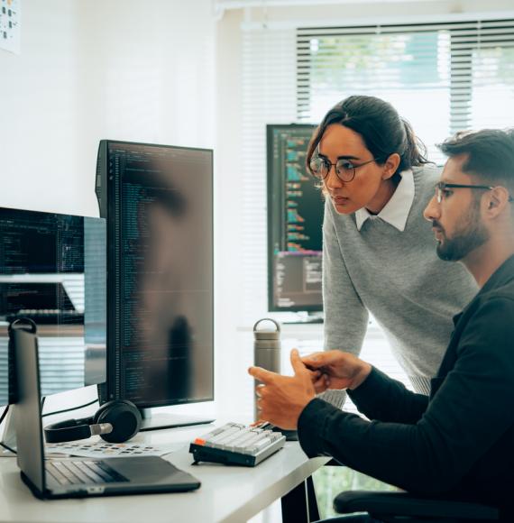 Two people looking at AI research