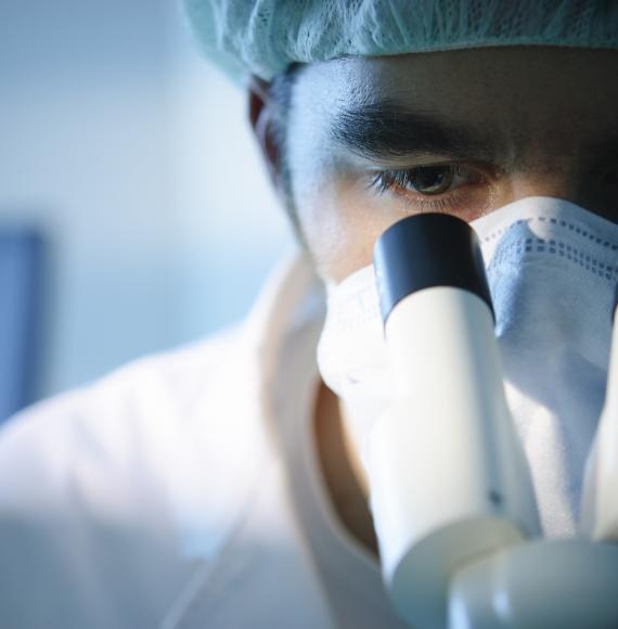 Scientist using a microscope