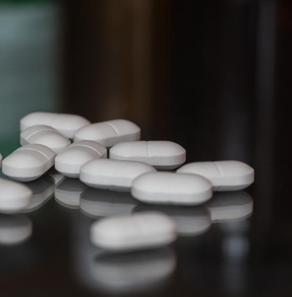 White pills on a dark surface