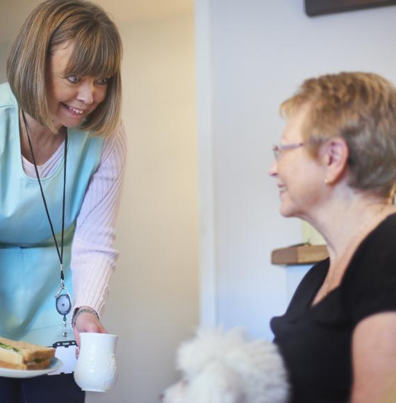 Female NHS volunteer with a patient