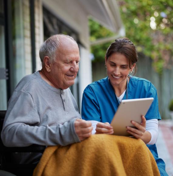Nurse giving care at home to an elderly man