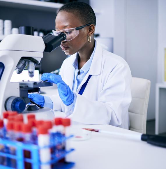Scientist looking into a microscope