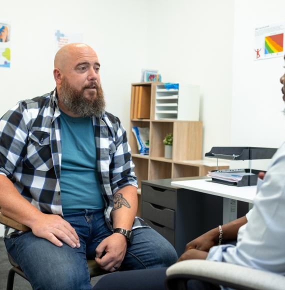 doctor sitting down with a male patient