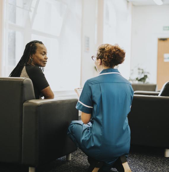 Nurse speaking to a patient in the waiting room