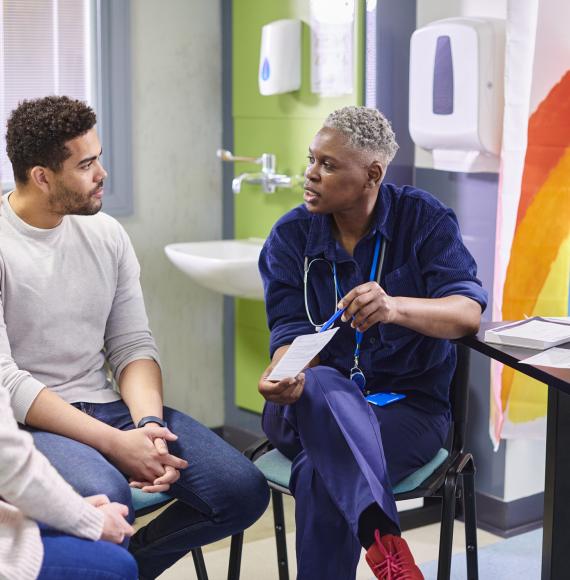 Doctor talking to a black male patient