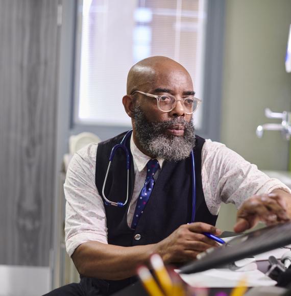 male gp working on a computer
