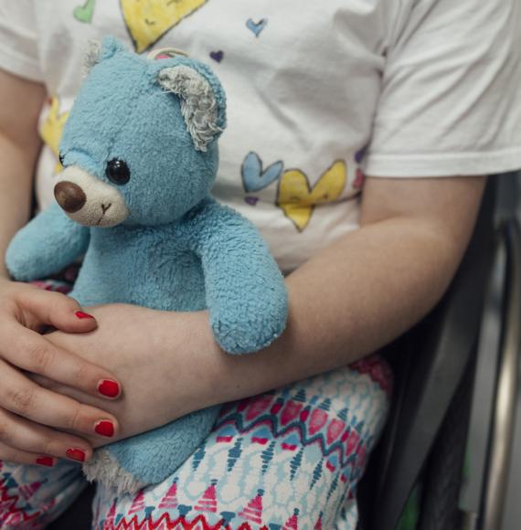 Small child holding a teddy bear