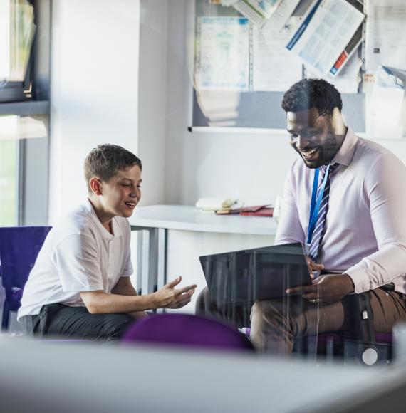 Teacher sat with a pupil
