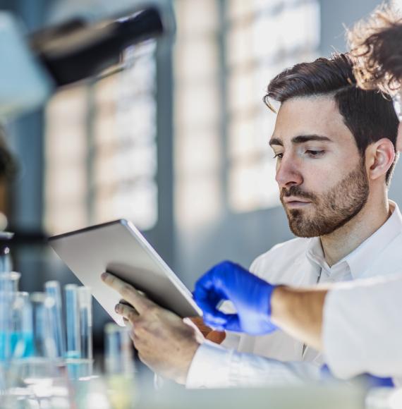 Two scientists using a tablet
