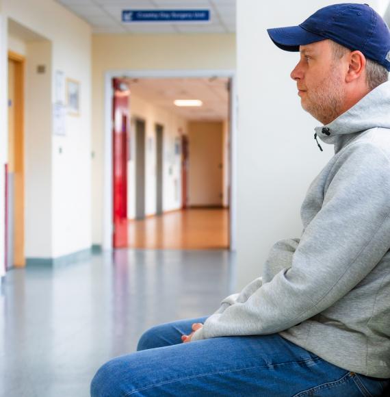 Man sat in a hospital corridor