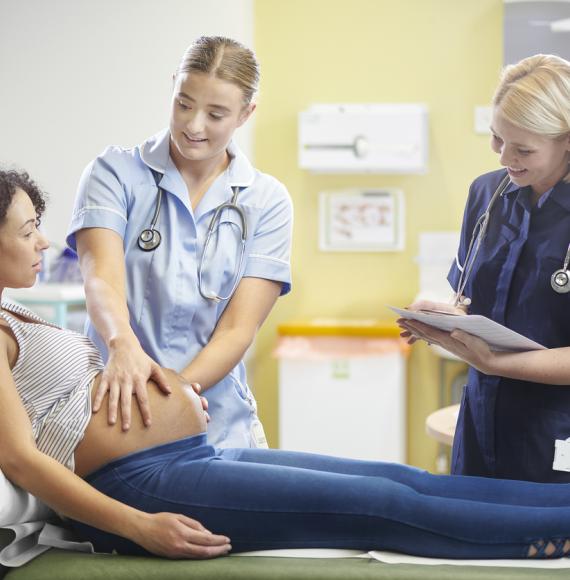 Pregnant woman with nurses