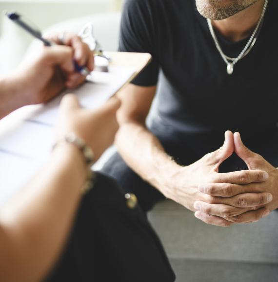 Man being supported with addiction