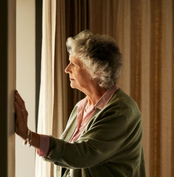 Lonely woman looking out of the window
