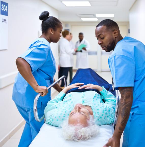 Nurses pushing woman on a hospital bed