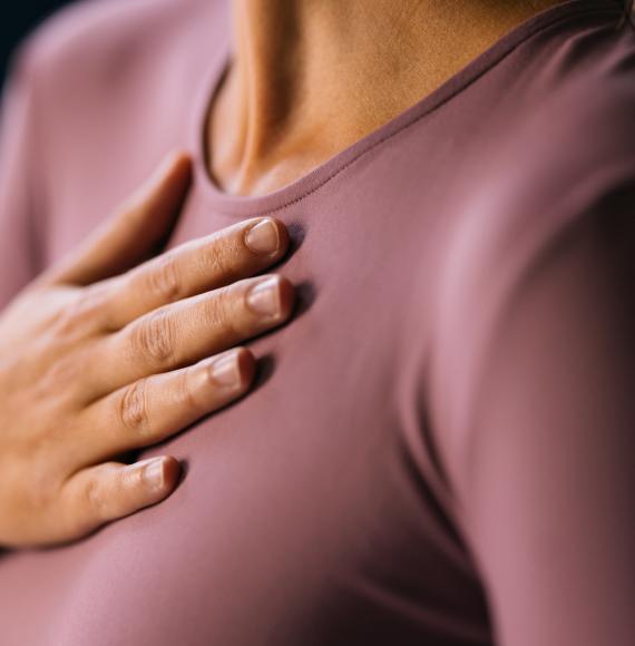 Woman with a hand on her chest