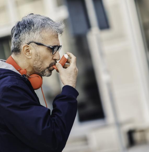 Man using an inhaler