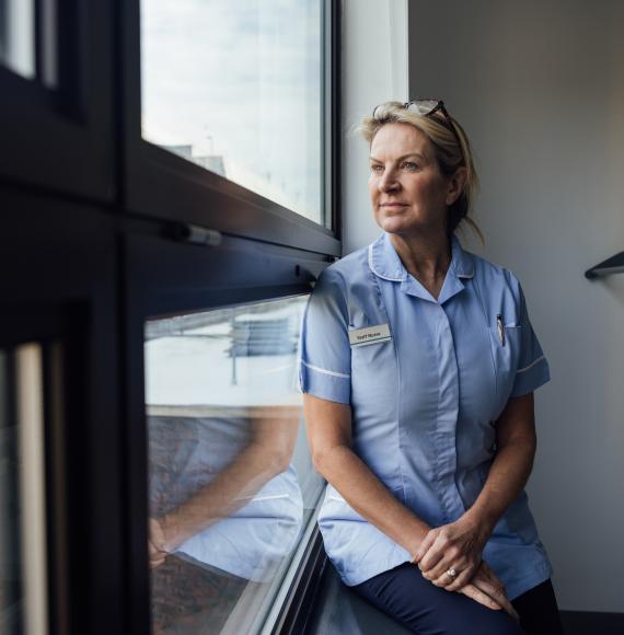Nurse looking out of a window