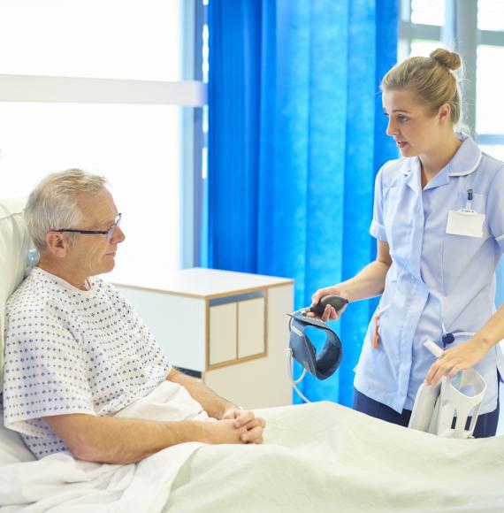 Nurse talking to a older male patient