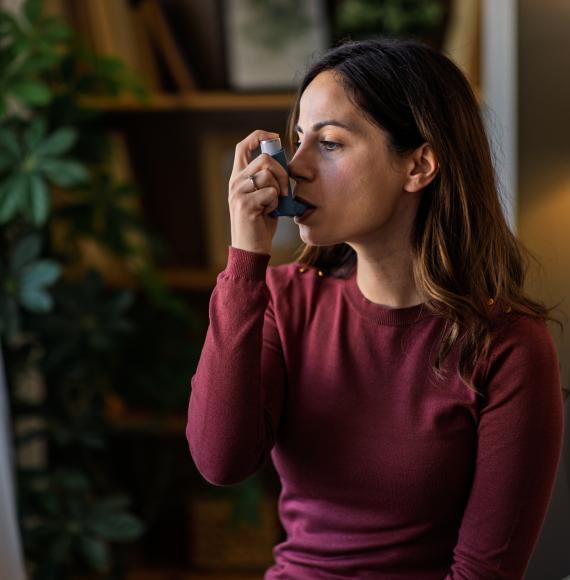 Woman using an inhaler