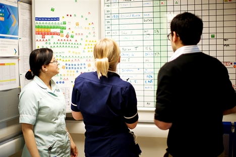 Staff looking at whiteboard edit